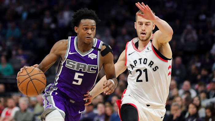 De'Aaron Fox dribbles the ball past Toronto Raptors guard Matt Thomas
